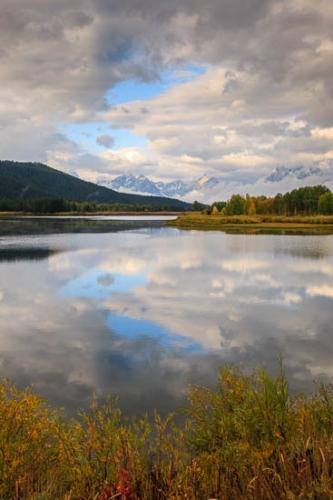 Autumn;Blue;Branches;Brown;Fall;Gold;Grand Tetons;Grand Tetons National Park;Green;Jackson Hole;Mirror;Mountain;Mountain Top;Mountainous;Mountains;Mountainside;Oneness;Orange;Pastoral;Peaceful;Pinnacle;Reflection;Reflections;Ripple;River;Snake River;Summit;Sunlight;Sunlit;Sunshine;Tan;Tree;Trees;Trunk;United States;Water;Wyoming;Yellow;zen