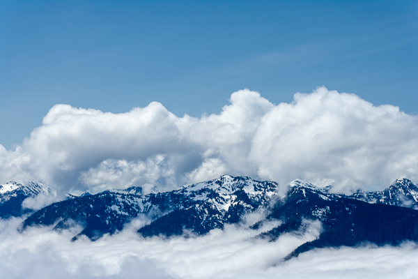 Blue;Bluff;Boulder;Calm;Cloud;Cloud Formation;Clouds;Cloudy;Concepts;Cool Colors;Cool Palette;Cool Tones;Green;Greens;Healing;Health care;Healthcare;High;Ledge;Looking up;Mist;Mountain;Mountain Side;Mountain Top;Mountainous;Nature;Obscured;Oneness;Peak;Photojournalism;Power;Precipice;Rock;Rock formations;Rocks;Scenic View;Scenics;Snow;Summit;Vertical;cliff;color;haze;landscape;misty;peaceful;powerful;restful;serene;sky;snowy;soothing;tranquil;zen