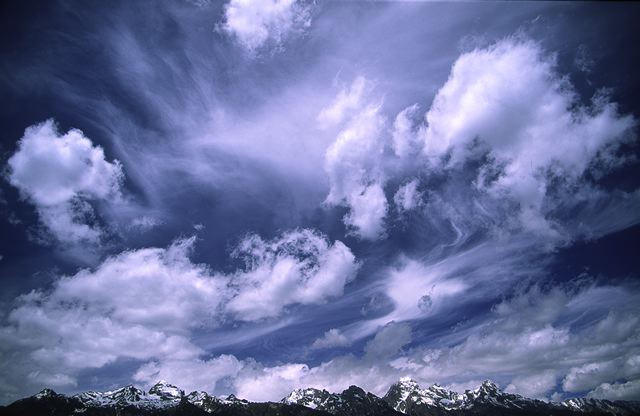 Ledge;Mountain;Cliff;Precipice;Peak;Mountain Top;Rock Formations;Rocks;Boulder;Nature;Vertical;High;Power;Powerful;Scenic View;Scenics;Summit;Sky;Clouds;Swirling;Blue