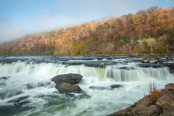 Autumn;Blue;Boulder;Branches;Calm;Cascade;Chute;Cloud Formation;Fall;Falls;Forest;Forested;Habitat;Healing;Minimalism;Mountain;Mountain Side;Mountain Top;Mountainous;Nature;New River;New River Gorge;Pastoral;Pouring;River;Rock;Rock formations;Rocks;Sandstone Falls;Stone;Stones;Streaming;Timberland;Tree;United States;Waterfalls;Waterscape;West Virginia;Woodland;Yellow;cliff;landscape;leaves;oneness;orange;peaceful;rapids;red;restful;serene;sky;soothing;tranquil;tree limbs;trees;waterfall;zen